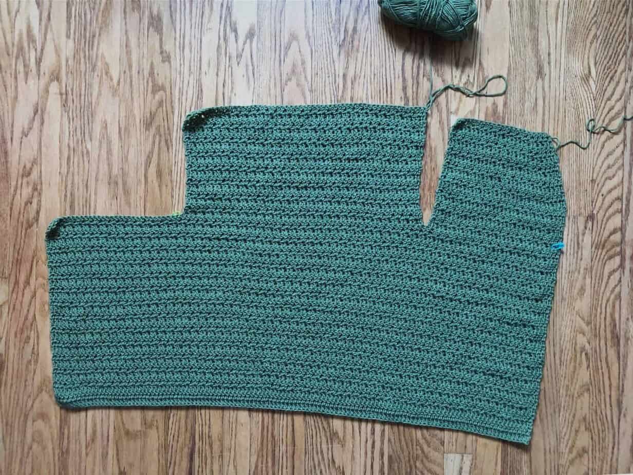picture of crochet cardigan in progress front and back panels on wood floor