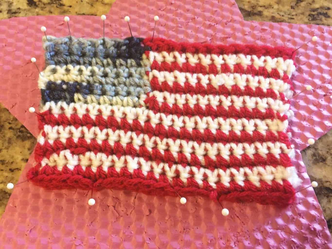 picture of crochet us flag pinned to pin foam for blocking