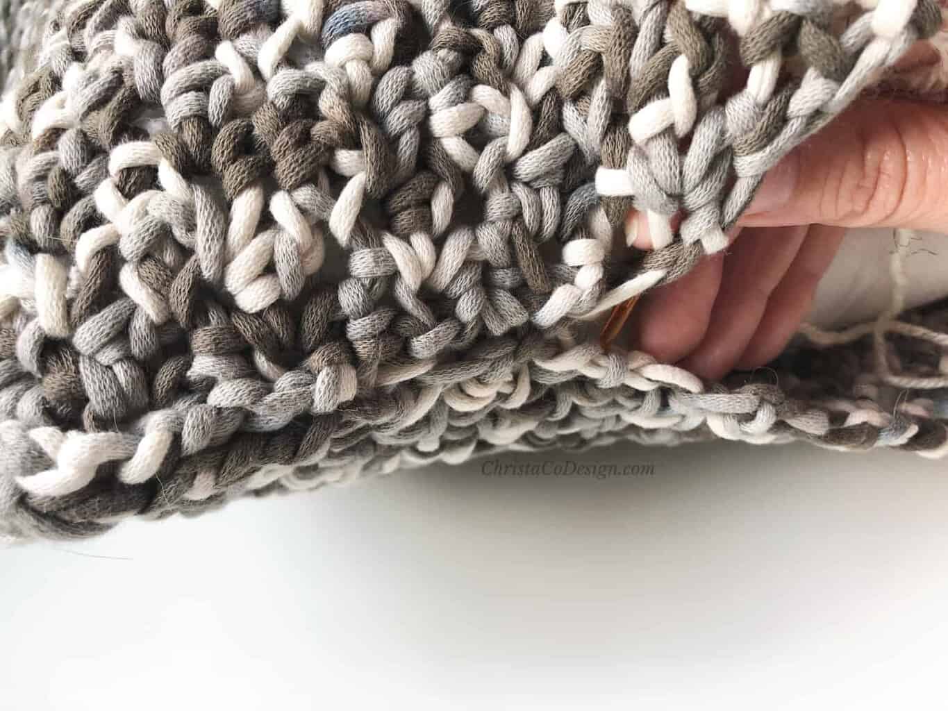 picture of hand in pillow seam
