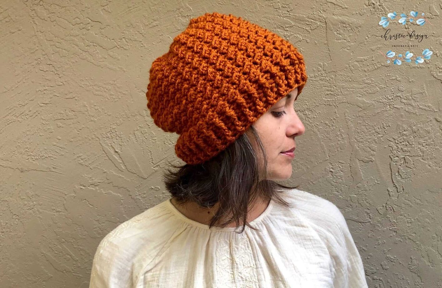 picture of woman in crochet textured hat rust colored