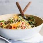 A fresh salad made with zucchini noodles, oranges, and a sesame dressing.