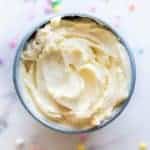 A bowl of white chocolate buttercream frosting.