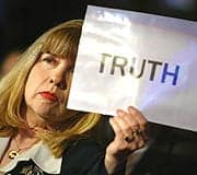 Sally Regenhard Sally Regenhard holds up sign with the word TRUTH