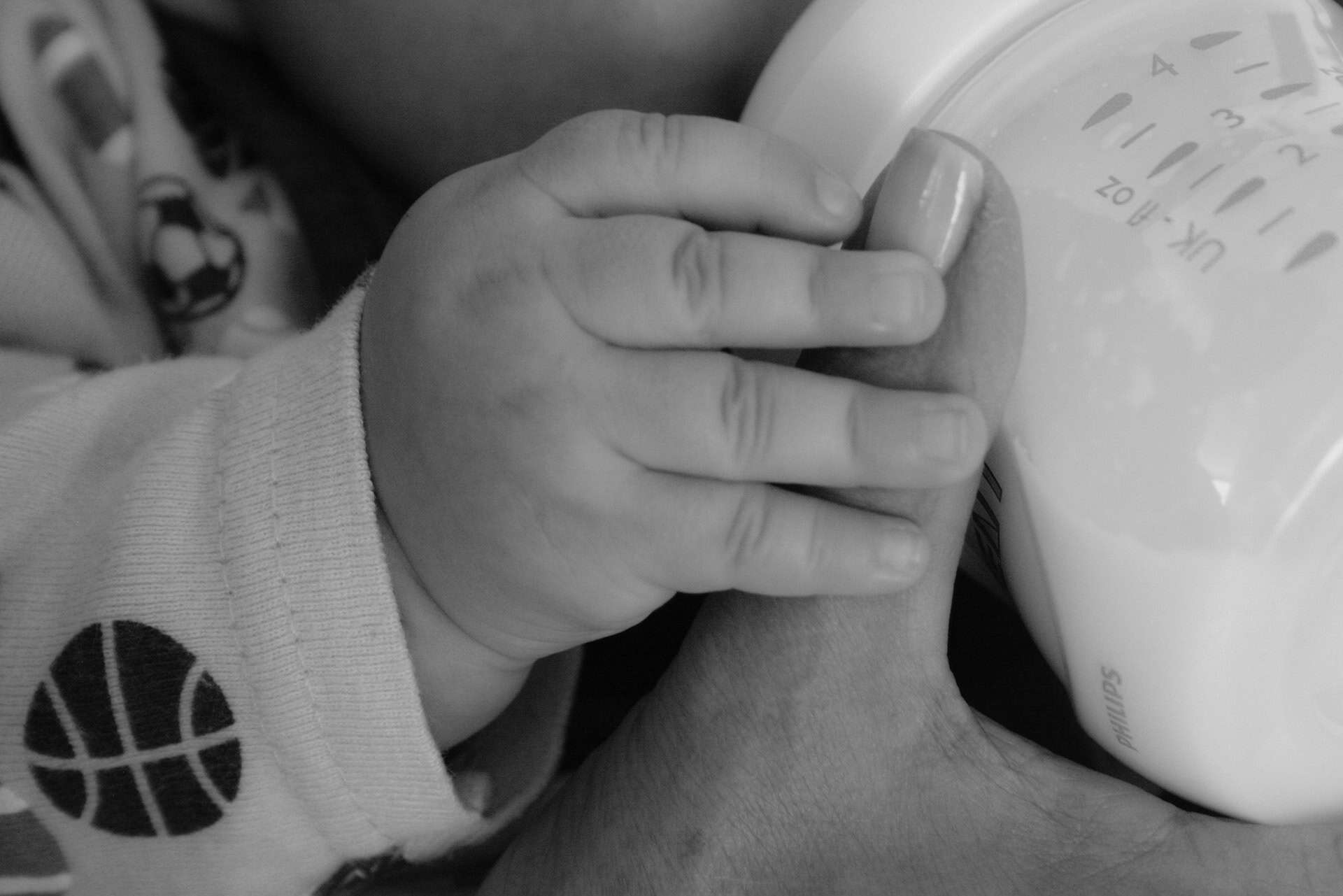 baby drinking from bottle Mama holding it