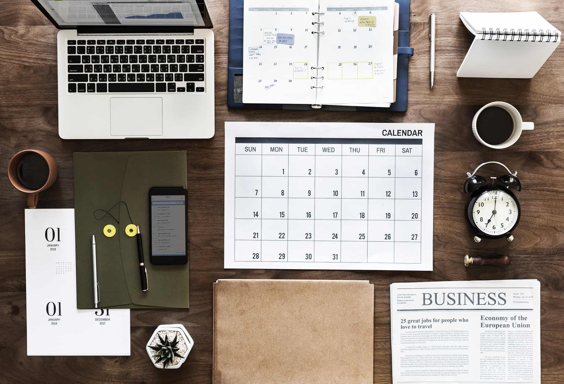 business table of laptop, paper, calendar etc