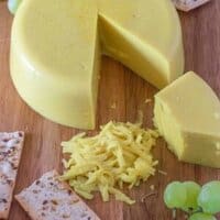 cheese board with cut up cheese