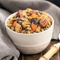 Maple Coconut Granola in a white cereal bowl with a spoon