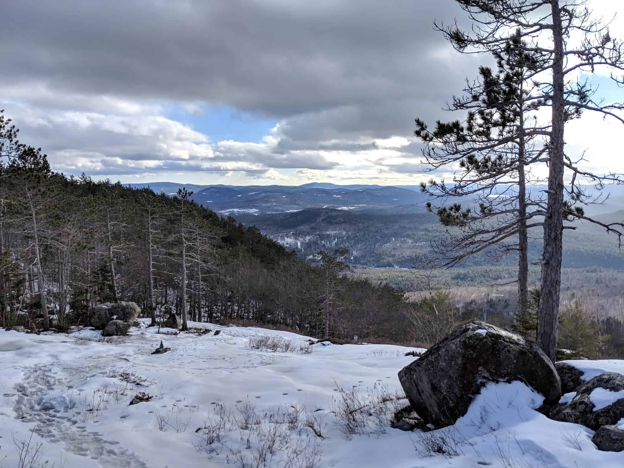 Looking for a hike in New Hampshire? Our trail guide to hiking South Mount Mountain in the winter includes what to bring, 3 ways to get there & more.