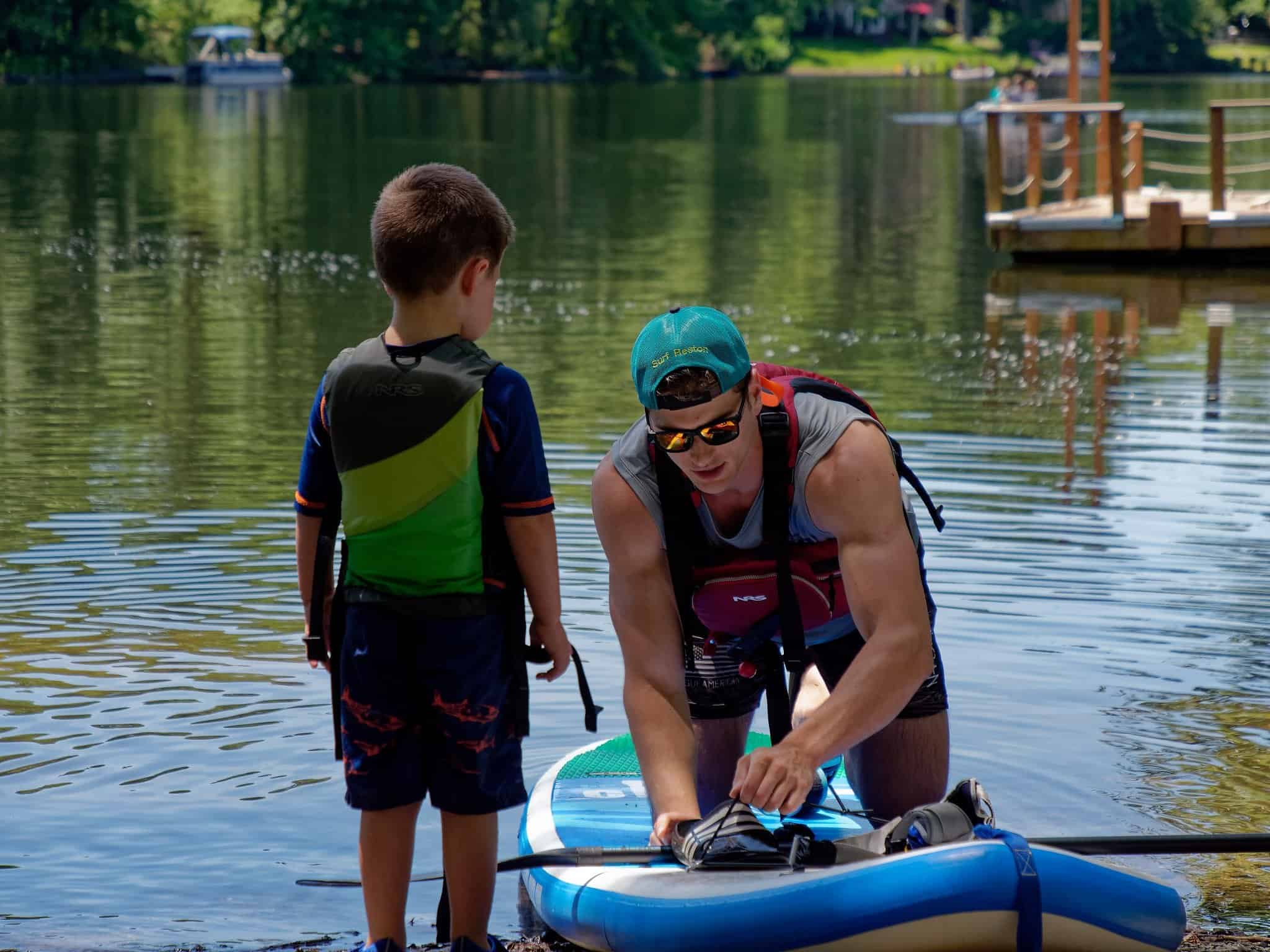 Small child beginner paddle boarder