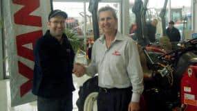 Steve Watt accepts the award from Derek Lane of PFG Australia.