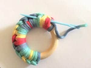 picture of needle sewing ends wood ring teether