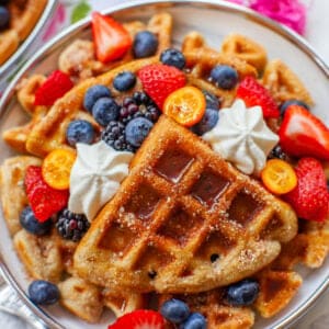 buttermilk cinnamon waffles with maple syrup, cream and fruit