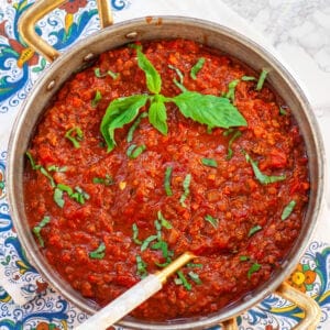homemade bolognese sauce with basil in copper pot