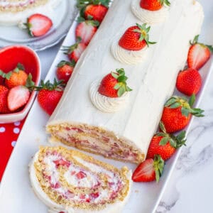 overhead view of strawberry cake with fresh strawberries and whipped cream frosting