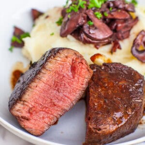 medium rare filet mignon steak with mushrooms and potatoes