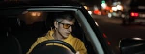 man driving at night with glasses