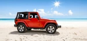 ed jeep with soft top in a beach