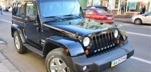 black jeep with tires in a street
