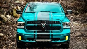 blue dodge ram with shocks in rough road