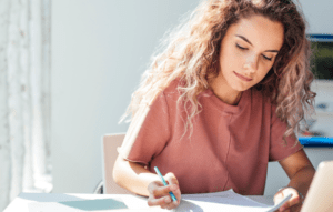 lease in writing image: woman writing a document with pen in hand