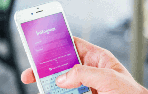 instagram screening tenants image of a hand holding a phone with the instagram app open