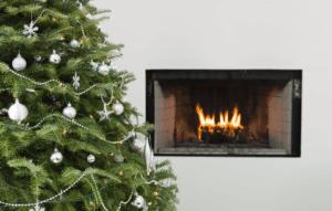 holiday fires image: christmas tree in front of a fireplace