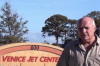Daniel Hopsicker in front of the sign for the Venice Jet Center