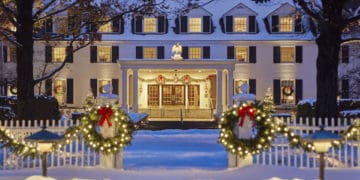 The woodstock inn in vermont offers guests a new england christmas with lots of locally cut trees, evergreen swags and lights.