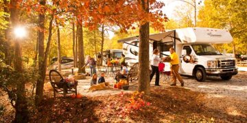 A family rv camping in the fall.