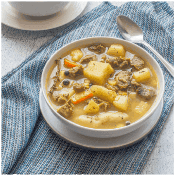 soup with mutton and vegetables in a white bowl