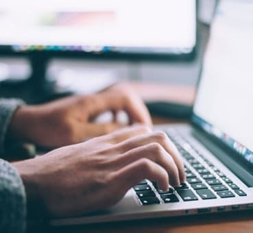 man on his laptop looking for an online counselling course hands of a man on his laptop looking for an e-therapy course