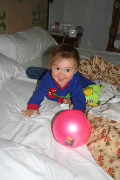 baby travel tips, Baby on Bed, baby in hotel