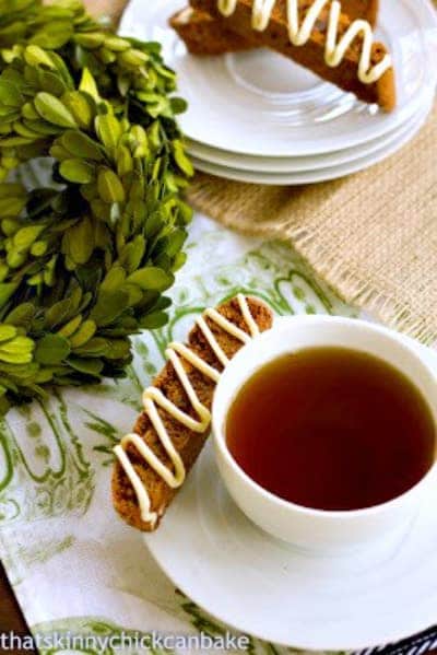 Gingerbread Biscotti - Perfect holiday treats! Gingerbread Biscotti on a stack of saucers and with a cup of tea