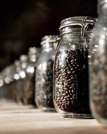 Glass jars full of coffee beans