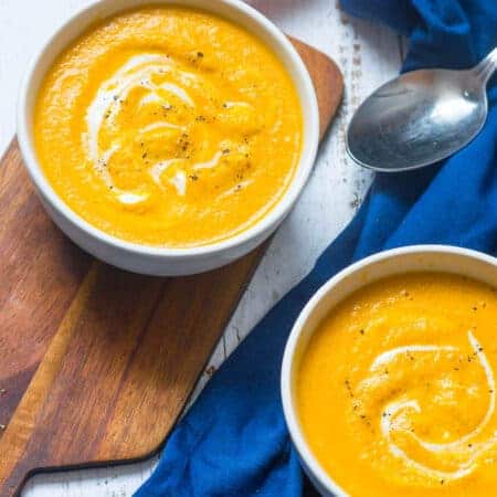 Two bowls of soup on a blue cloth