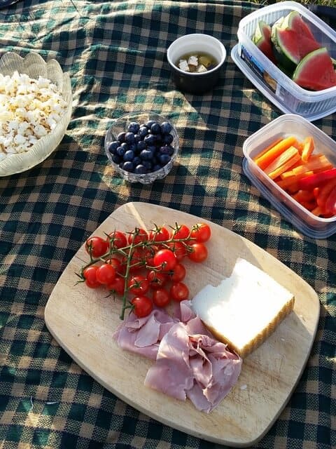A selection fo picnic foods on a cutting board.