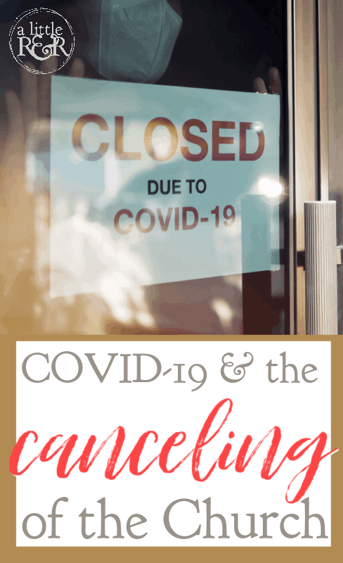 person with mask looking in store window with closed sign due to COVID-19