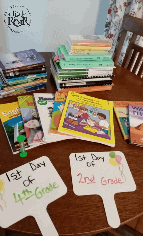 homeschool curriculum and supplies on a kitchen table