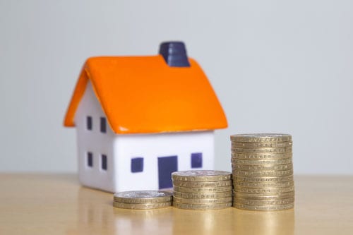 house with stack of coins