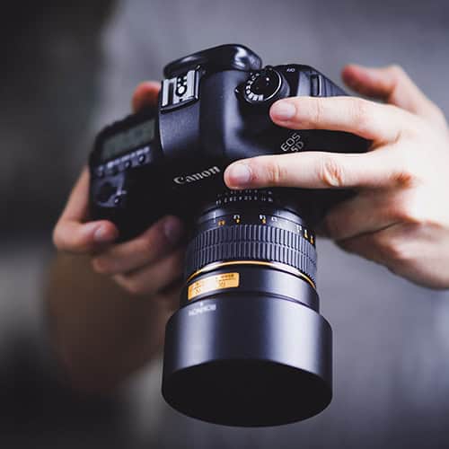 DSLR Camera in hands of photographer