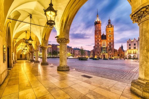 St. Mary's Basilica in the Main Square of Krakow, Poland at dusk.