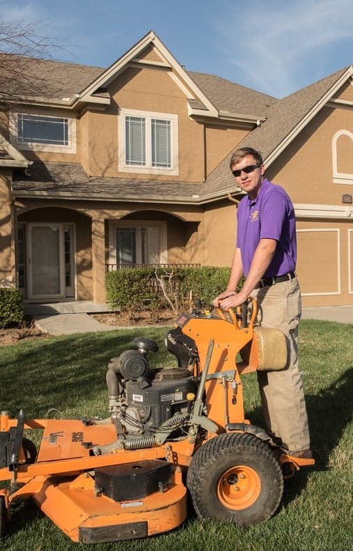 Employee on standing mower
