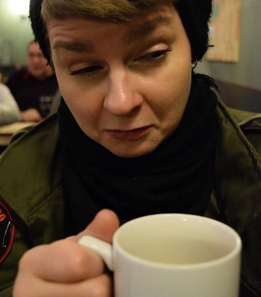 Woman reacting to bitter coffee