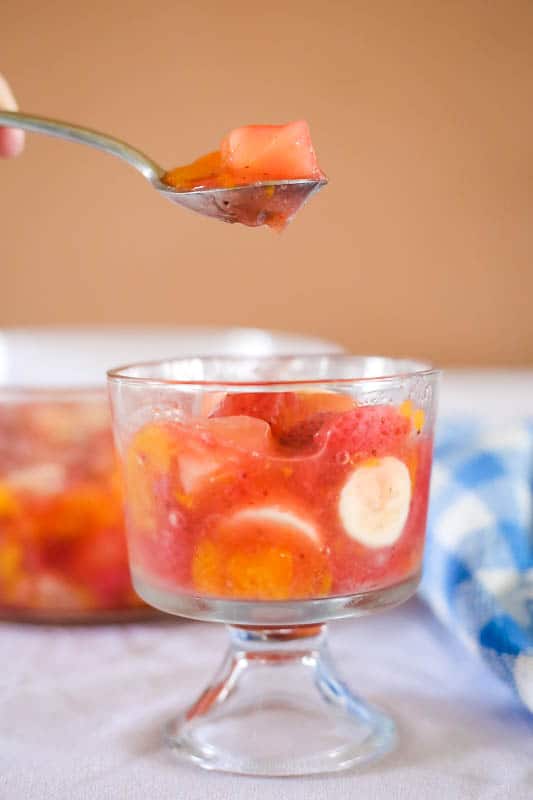 spoon eating fruit salad with peach pie filling