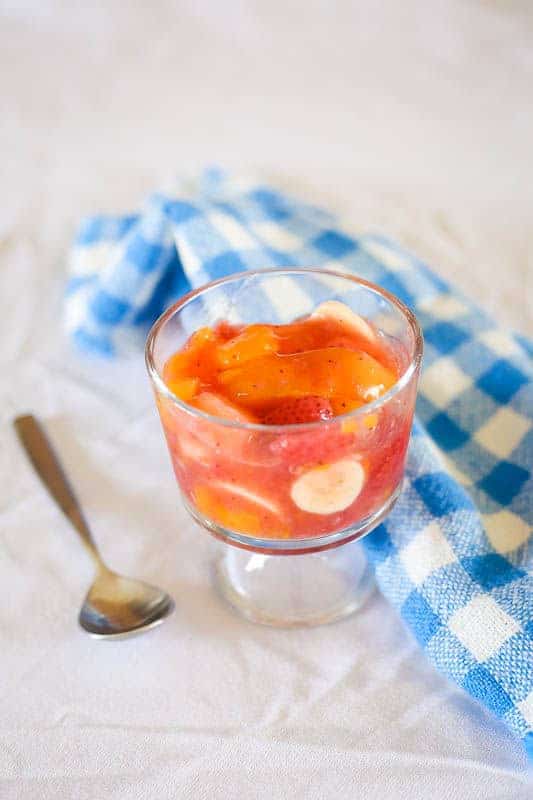 fruit salad with peach pie filling on table with white table cloth