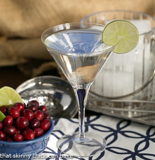 White Cosmopolitans - A festive twist on the classic cocktail! White Cosmopolitans garnished with a slice of lime