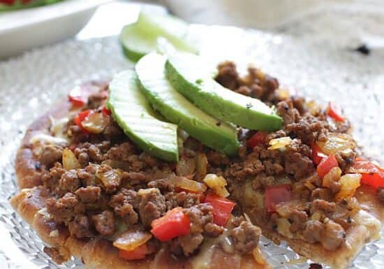 Cooked Ground Beef with Cheese and Sliced Avocados served on Pita bread pizza crust