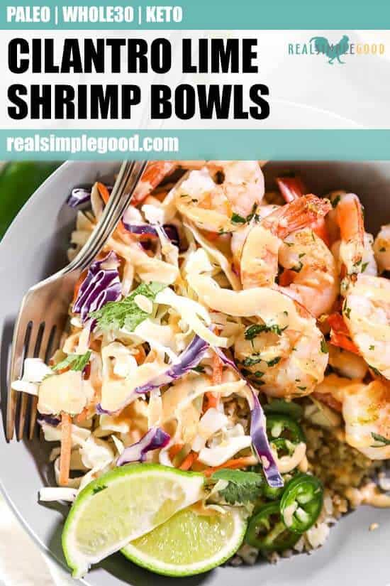 Close up shot of cilantro lime shrimp bowl with fork in it, topped with sauce, jalapeño slices and lime wedges.
