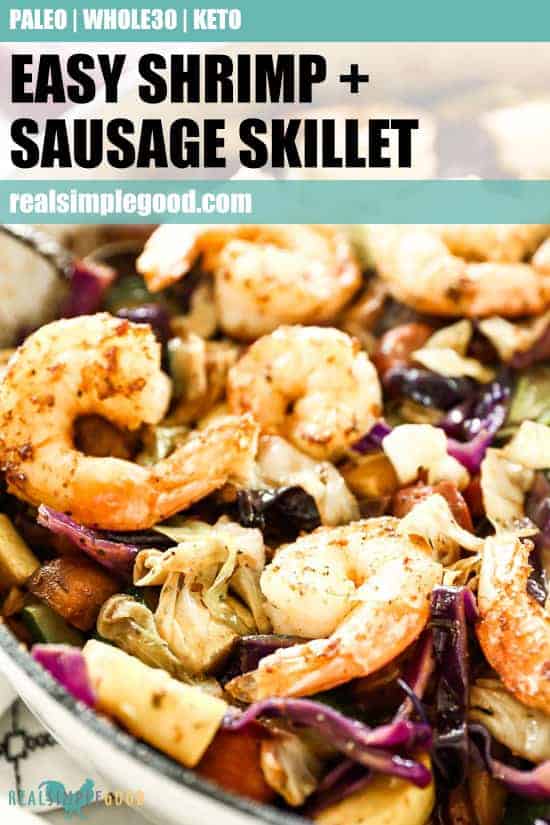 Close up of sausage and shrimp in skillet with other veggies and text overlay at top for pinterest.