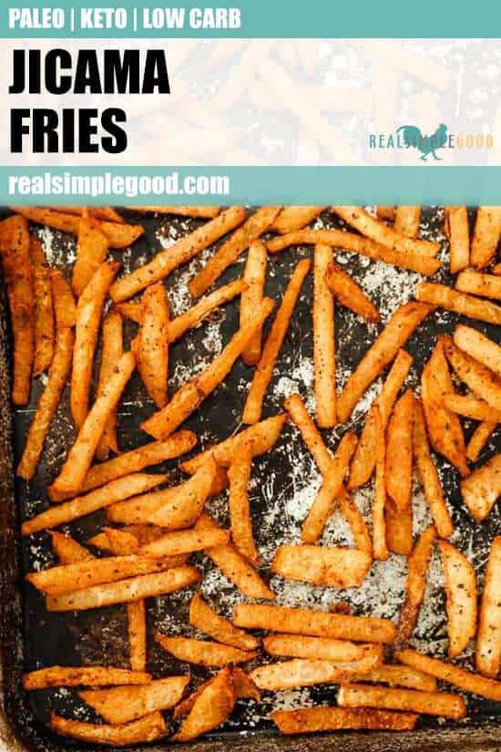 Vertical image with text overlay of jicama fries spread out on a sheet pan.